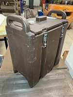 Front and side view of brown Cambro insulated beverage dispenser showing overall shape and condition