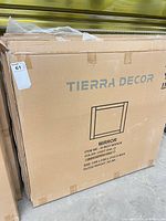 Front of boxed Tierra Decor mirror showing branding and product illustration