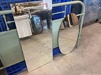 Both mirrors leaning against metal frame