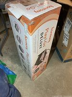 Sealed retail carton showing Harmony Play & Go Deluxe Portable Playard