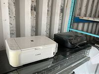 Canon printer and HP printer on shelf