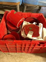 Red tote containing stacked dinner and side plates, crock and bowls