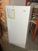 Front view of white Woods refrigerator showing full height and door handle