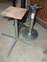 Two chrome table bases side by side showing overall form