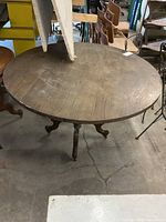 Full view of table showing round top on pedestal base