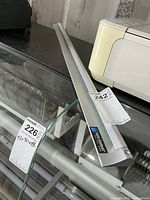 Full view of 36-inch aluminum ticket holder on glass surface