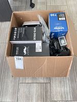 Box showing multiple sealed toner and drum boxes and phone