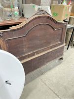 Front view of full footboard showing arched design and wear