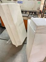 Two of the white rectangular plastic tanks standing upright