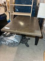 Full view of rectangular table showing wooden top and base connection