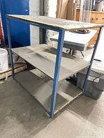 Overall view of blue metal three-shelf cart