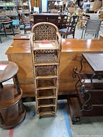 front view of tall wicker rack with seven shelves