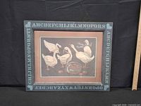 front view of framed folk art duck print with alphabet border