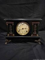 Front view of black wooden Sessions mantel clock