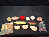 Entire set of 11 ceramic fruit and vegetable magnets with display card on black backdrop