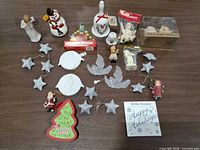 All items laid out: figurines, bell, Ornamotion box, salt & pepper shakers, star, dove and round ornaments, playing cards