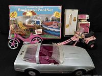 Overall lot showing pool set box, pink bike, grey convertible, quad bike, fridge, kitchen range