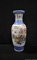 Full view of porcelain vase showing peacock and floral design