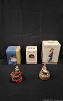 Entire lot showing three boxed items and two unboxed music boxes