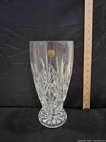 Full view of crystal vase beside ruler