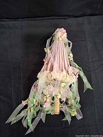 Parasol folded with ribbons and flowers visible