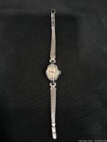 Silver-tone Timex wristwatch, full view front showing mesh bracelet and round dial