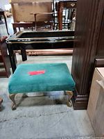 front angled view showing green upholstered top and gold-tone cabriole legs