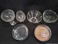 Six glass items laid out on black backdrop