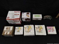 All items laid out: two Hot Pot boxes, novelty box, metal napkin holder, Monterey stoneware box, four napkin packs