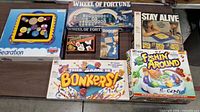 All seven boxed games laid out on table