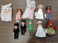Group shot of all eight dolls and two McDonald’s polybags on table