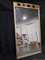 Front view showing full mirror with gold frame and decorative copper panel