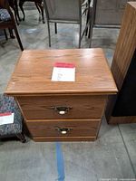 Full front view of nightstand showing drawers and hardware