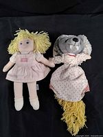 Front view of both plush dolls side by side