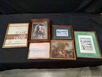 All six framed items lined up on black backdrop