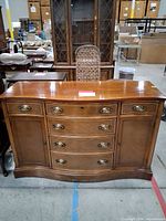 Full front view of sideboard buffet showing drawers, doors, pulls