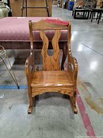 Front view of wooden child rocking chair