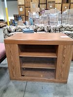 Front view of oak TV stand showing glass door and shelves