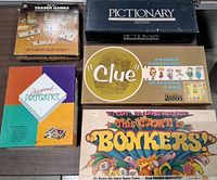 All five game boxes arranged on surface showing titles and wear