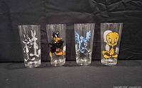 Four Looney Tunes character glasses lined up: Bugs Bunny, Daffy Duck, Road Runner, Tweety