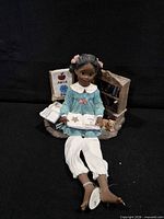 Girl figurine reading with accessories