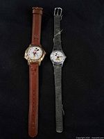 Both Lorus Mickey Mouse watches side by side showing cases, dials and straps