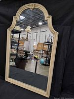 Front view of arched mirror reflecting warehouse