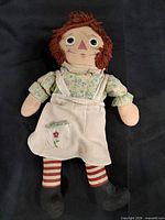 Front view of Raggedy Ann cloth doll showing outfit and facial details