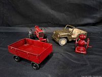 Group shot showing all four vintage metal toys