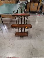 Front view showing entire rack with two shelves and scrollwork