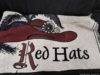 Full view of blanket showing red hat illustration and partial poem text