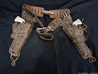 Full view of double holster belt with two pistols inserted