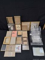 Full lot overview showing metal photo frames laid out and stacked acrylic stands