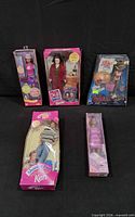 Group image of all five boxed dolls